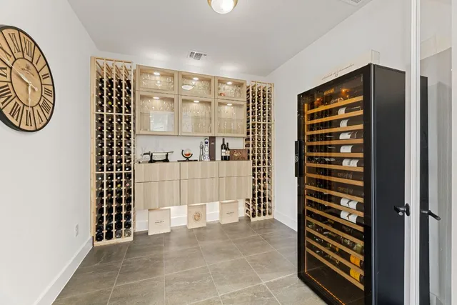 a bedroom with a bed a chandelier and a large window