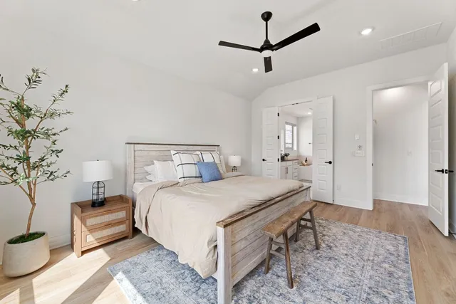 a spacious bathroom with a double vanity sink a mirror and a bathtub