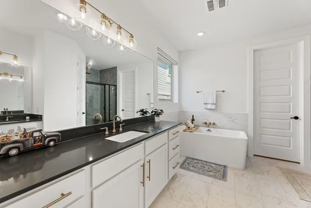 a en suite bathroom with double sink and a mirror