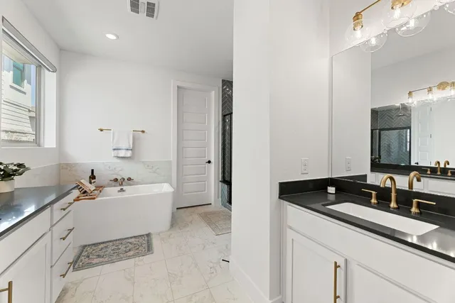 a bathroom with a bathtub and a shower