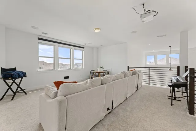 a living room with furniture and a chair