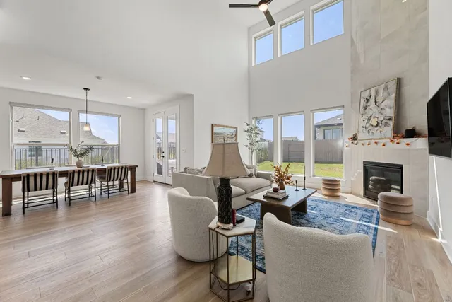 a living room with fireplace furniture and a wooden floor