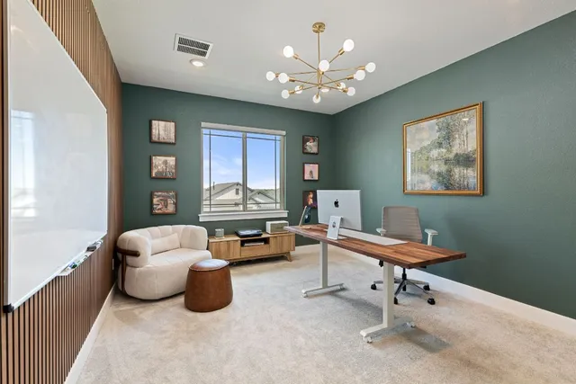 a workspace with furniture and chandelier