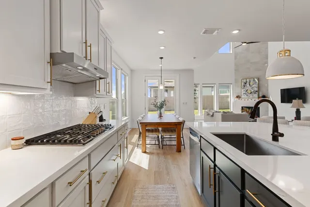 a living room with furniture a fireplace and a floor to ceiling window