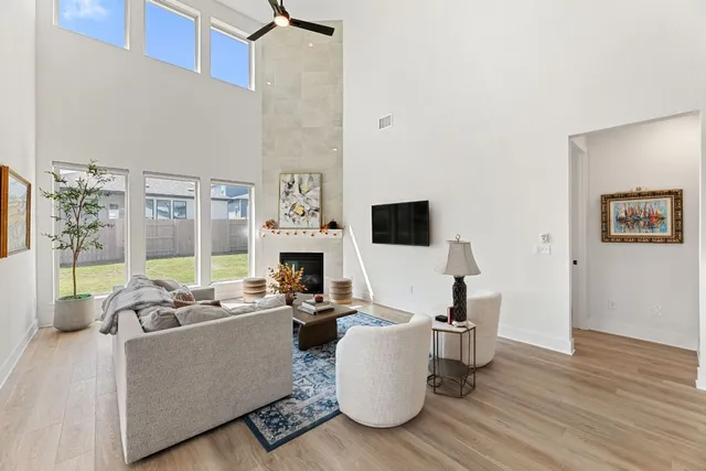 a living room with furniture and a view of kitchen