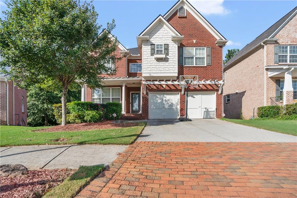 a front view of a house with a yard and garage
