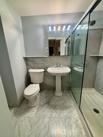 a bathroom with a sink toilet and shower