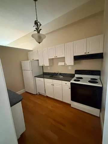 a kitchen with stainless steel appliances a stove a sink and cabinets