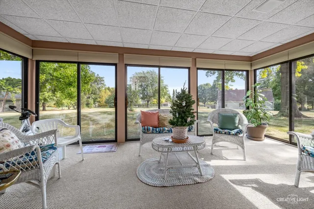 a living room with furniture and a floor to ceiling window