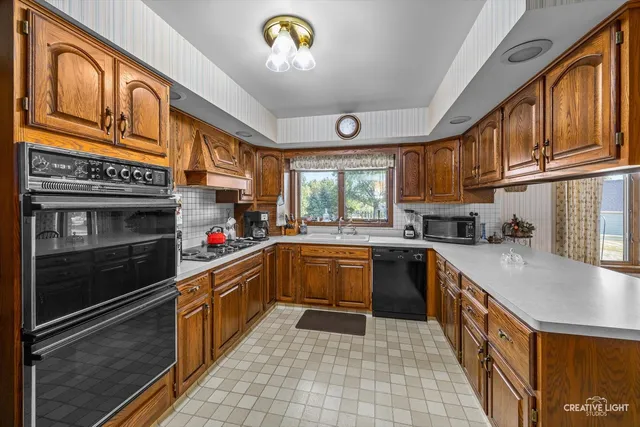 a kitchen with stainless steel appliances granite countertop a stove and a sink