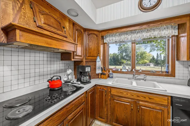 a kitchen with stainless steel appliances granite countertop a refrigerator stove and sink