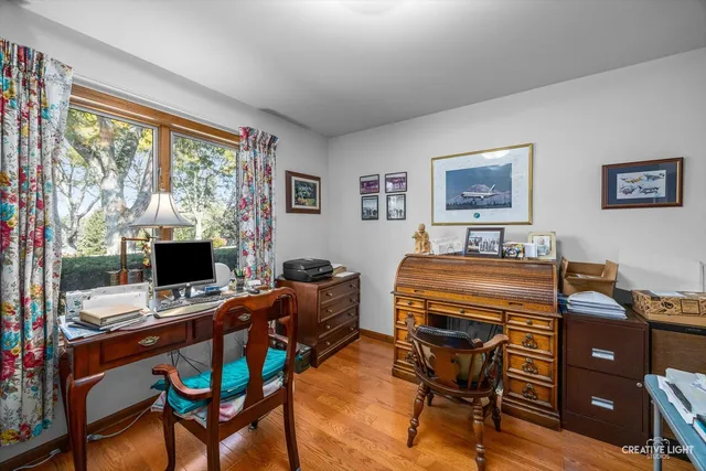 a view of a hallway with workspace and mirror