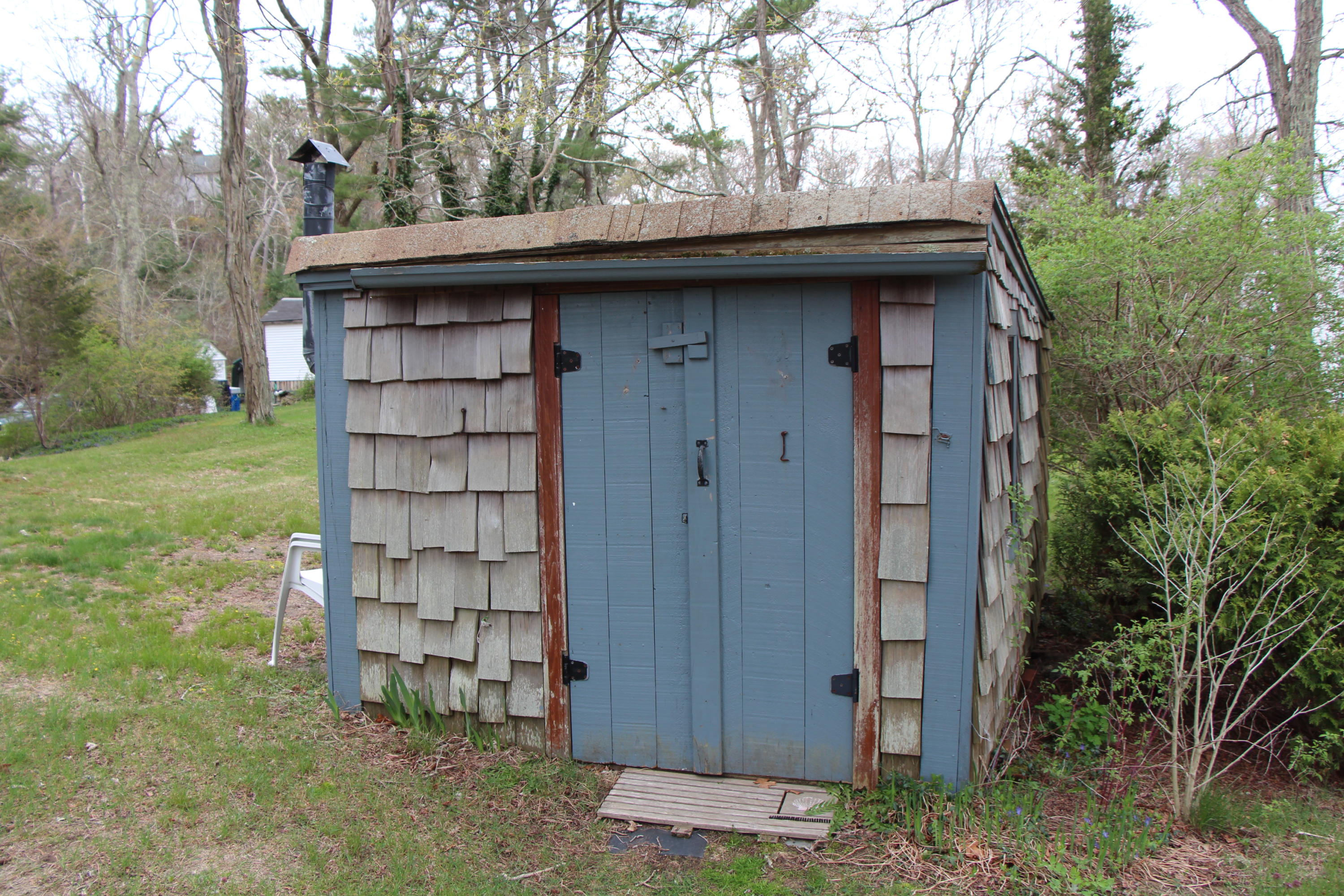 265 County Road Monument Beach, MA 02532 - Photo 6 of 35 a view of a wooden door and a trees in the background