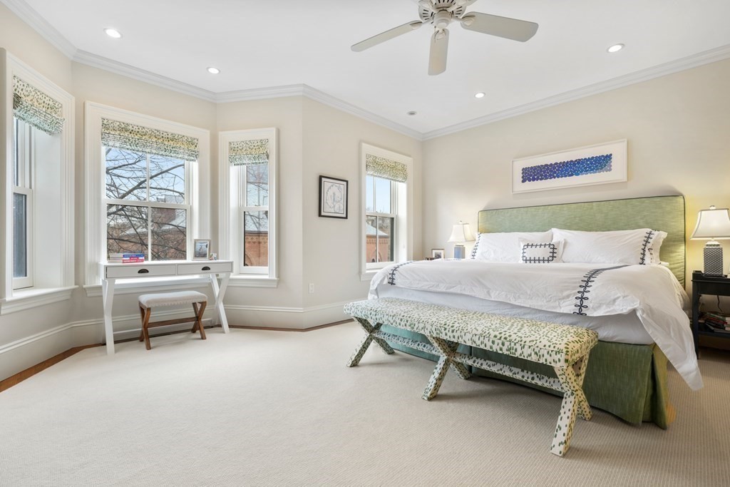 173 Warren Avenue, Unit 2 Boston, MA 02116 - Photo 13 of 32 a bedroom with a bed and a chandelier