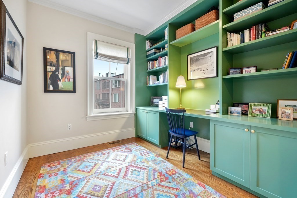 173 Warren Avenue, Unit 2 Boston, MA 02116 - Photo 15 of 32 a room that has a bookshelf and a chair in it