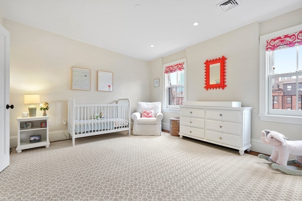 173 Warren Avenue, Unit 2 Boston, MA 02116 - Photo 24 of 32 a bedroom with furniture and a window