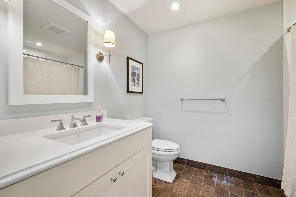 173 Warren Avenue, Unit 2 Boston, MA 02116 - Photo 27 of 32 a bathroom with a sink toilet and vanity