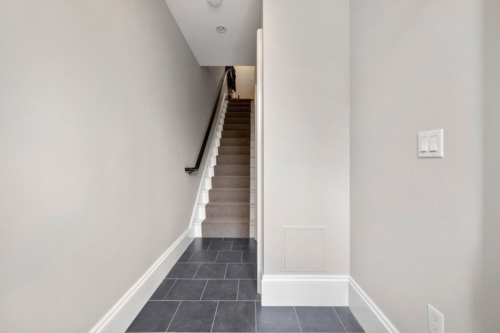 173 Warren Avenue, Unit 2 Boston, MA 02116 - Photo 30 of 32 a view of a hallway with wooden floor and staircase