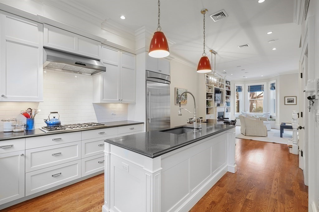 173 Warren Avenue, Unit 2 Boston, MA 02116 - Photo 8 of 32 a kitchen with granite countertop a sink cabinets and wooden floor