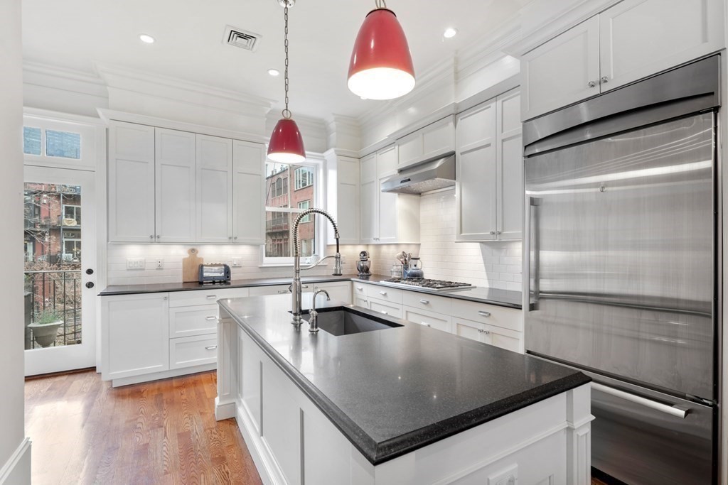 173 Warren Avenue, Unit 2 Boston, MA 02116 - Photo 9 of 32 a kitchen with a refrigerator a sink and cabinets