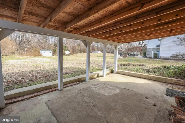 a view of a house with a yard covered in snow