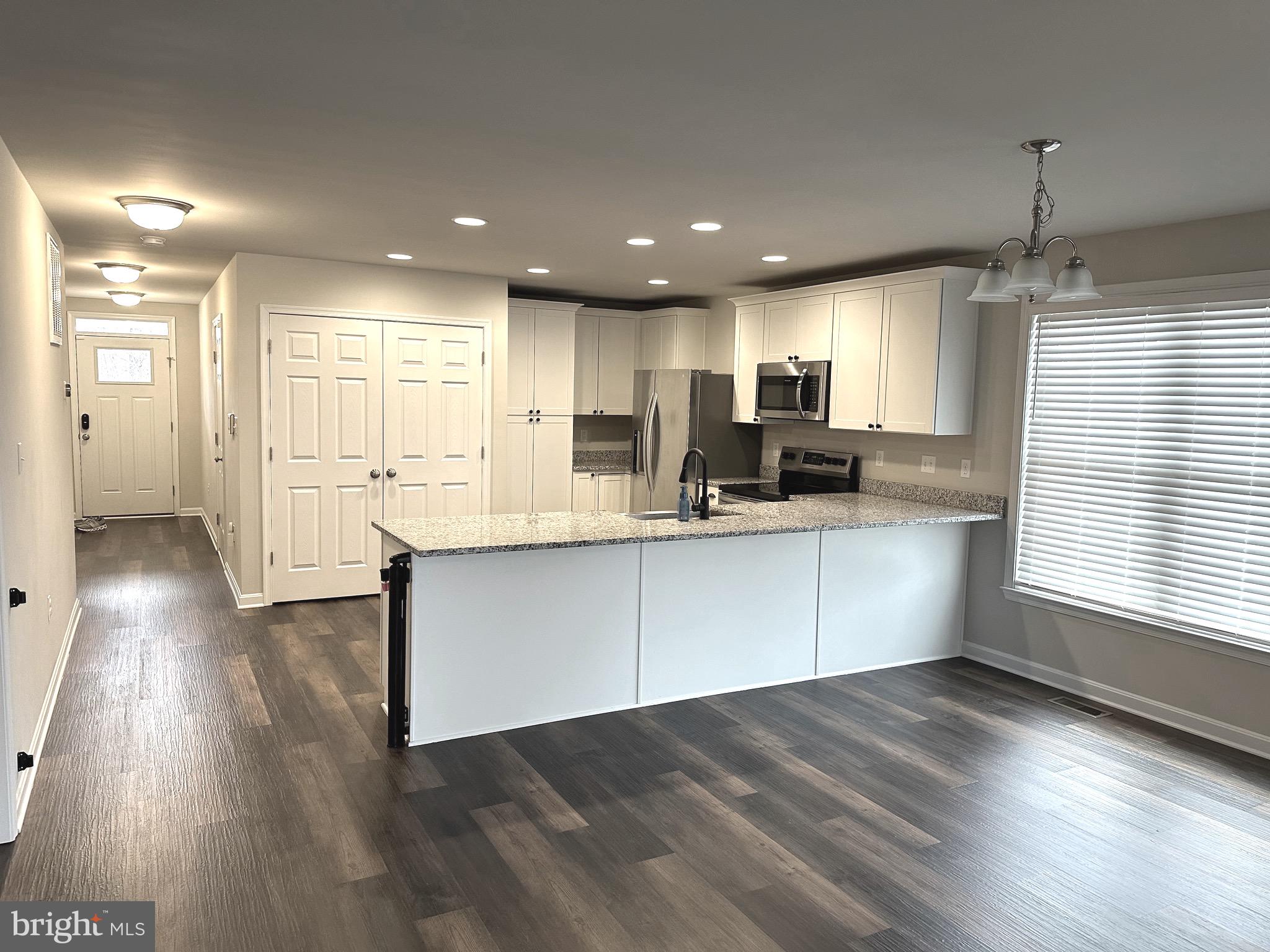 275 Nicholson Drive Colonial Beach, VA 22443 - Photo 2 of 22 a kitchen with stainless steel appliances granite countertop a refrigerator a sink dishwasher a oven and a large island with wooden floor