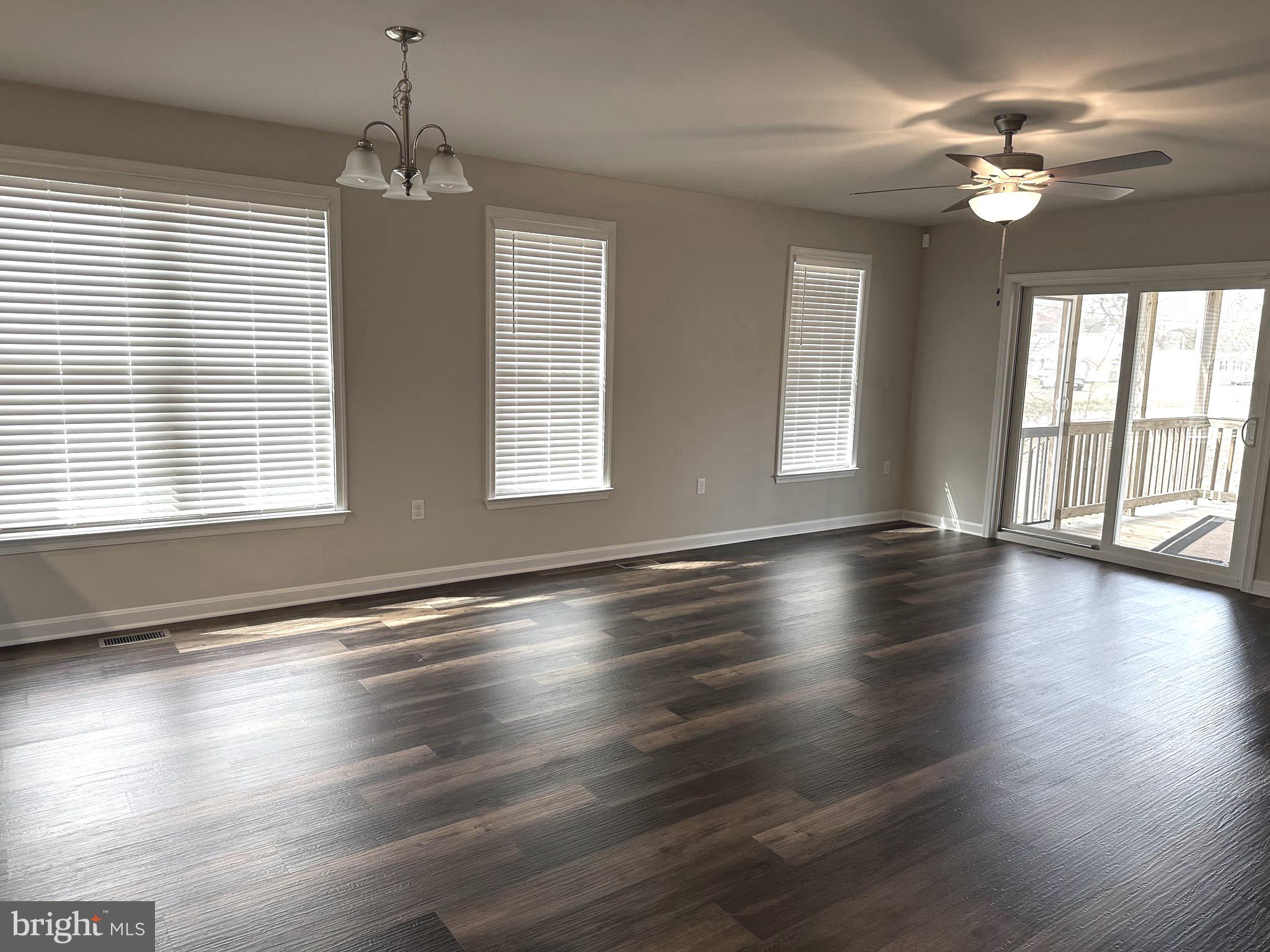 275 Nicholson Drive Colonial Beach, VA 22443 - Photo 8 of 22 an empty room with wooden floor and windows