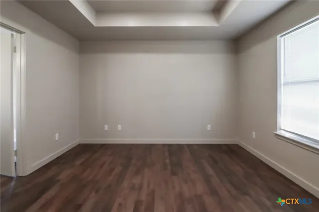 a view of room with window and wooden floor