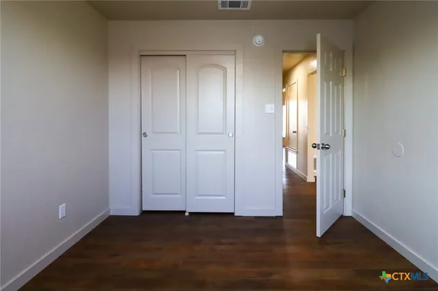 an empty room with wooden floor