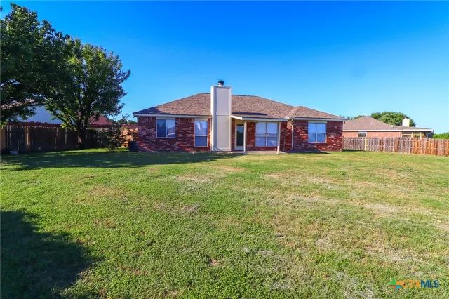 a front view of a house with yard and green space