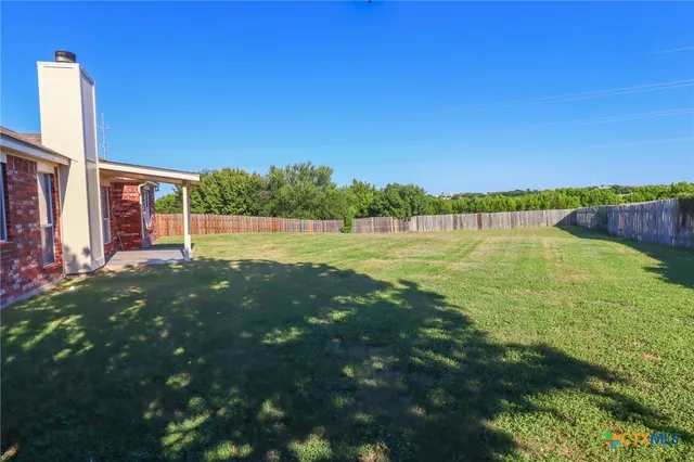 a view of outdoor space with deck and green yard