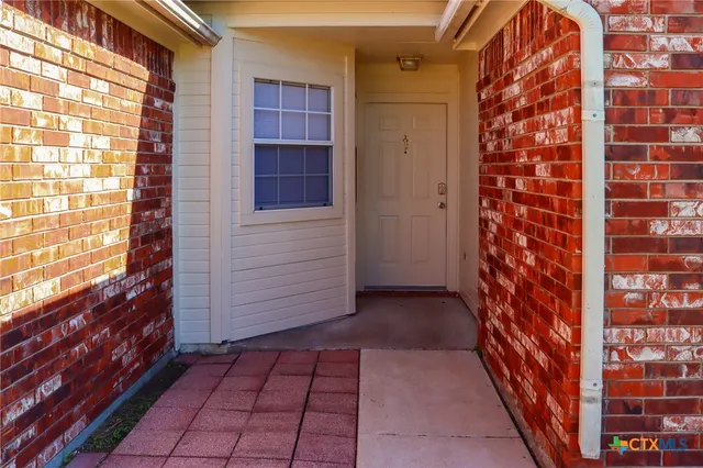 a view of a brick house with a outdoor space