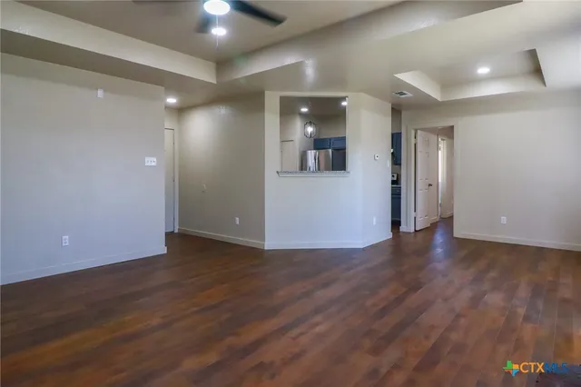 a view of a hallway with wooden floor