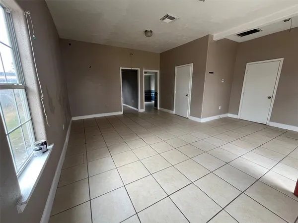 a view of an empty room and a window