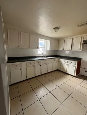 a kitchen with stainless steel appliances granite countertop a sink and cabinets
