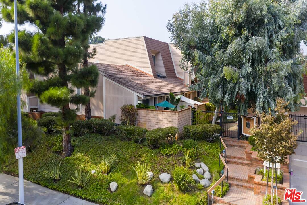 a aerial view of a house with swimming pool garden and patio