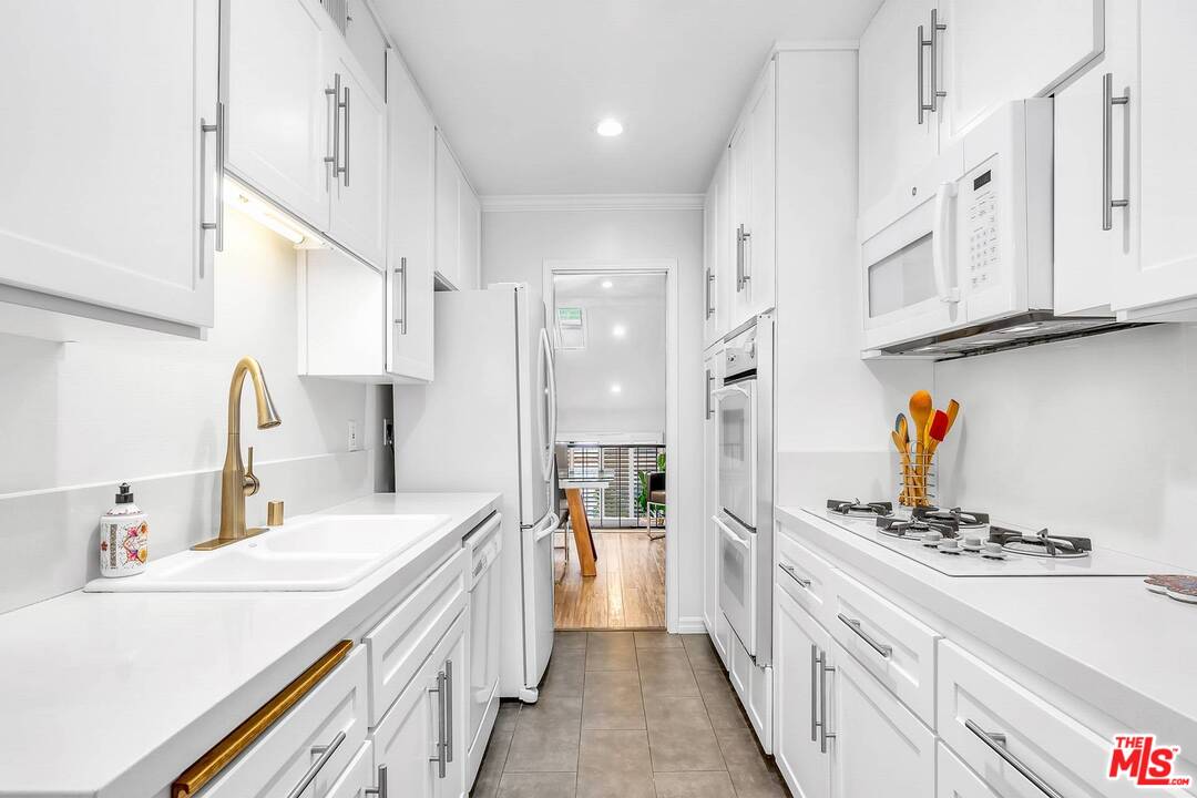 13035 Mindanao Way, Unit 2 Marina del Rey, CA 90292 - Photo 11 of 29 a large white kitchen with stainless steel appliances