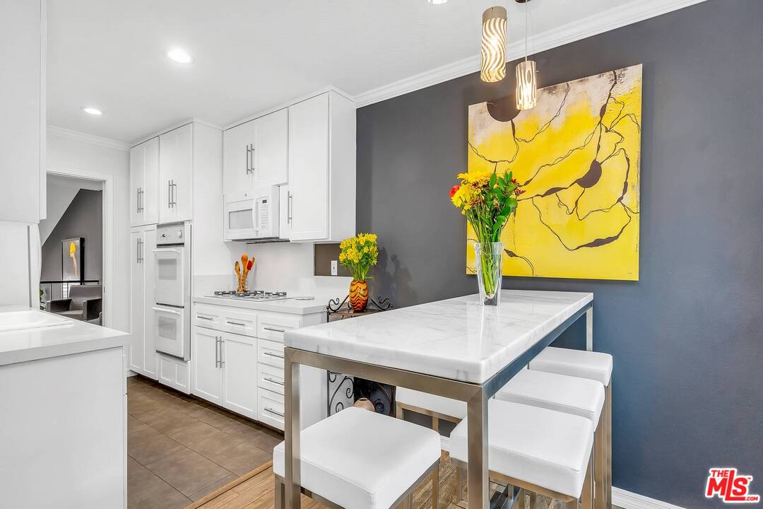 13035 Mindanao Way, Unit 2 Marina del Rey, CA 90292 - Photo 13 of 29 a kitchen with stainless steel appliances cabinets and wooden floor