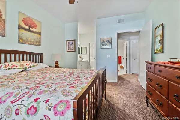 a bedroom with a bed and a dresser in it