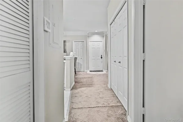 a view of a hallway with wooden shelves