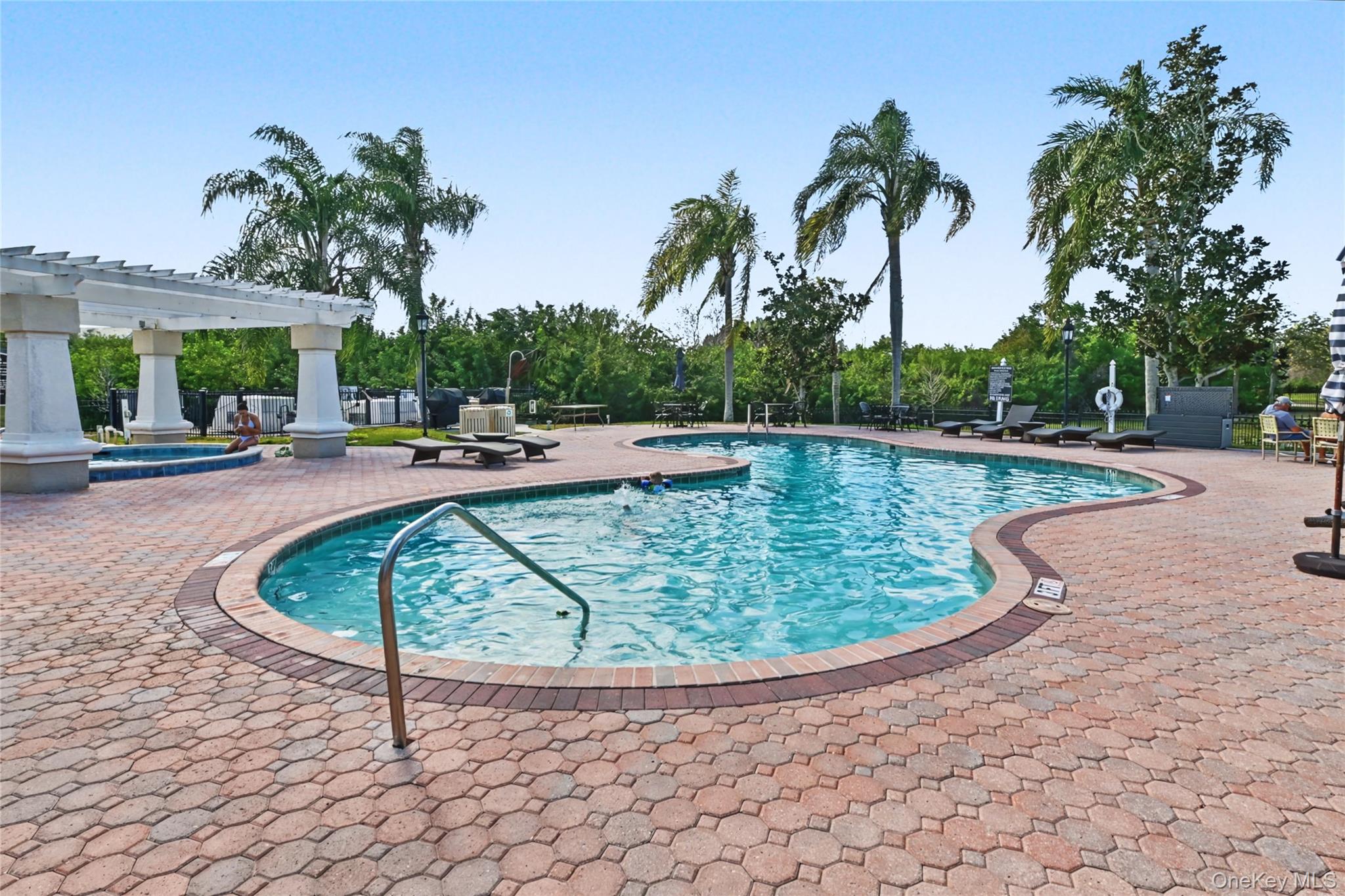 5174 Northridge Road, Unit 211 Sarasota, FL 34238 - Photo 20 of 29 a view of a swimming pool with a patio and a garden