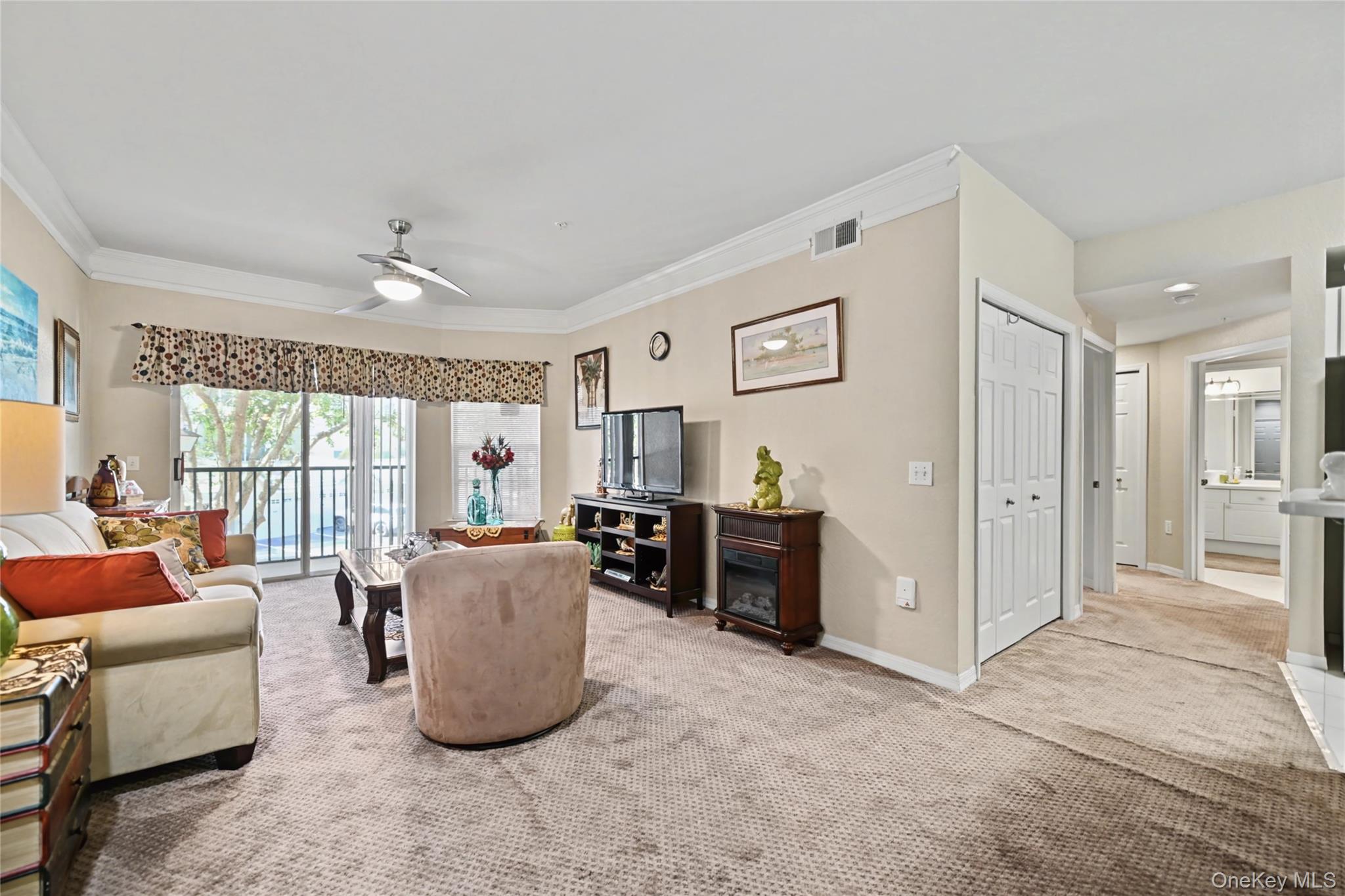 5174 Northridge Road, Unit 211 Sarasota, FL 34238 - Photo 3 of 29 a living room with furniture and a large window