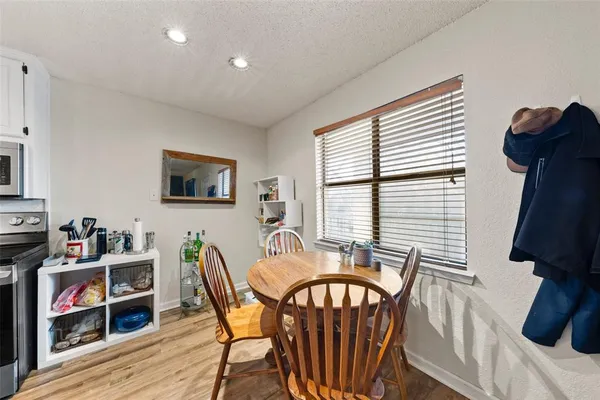 a dining room with furniture and wooden floor