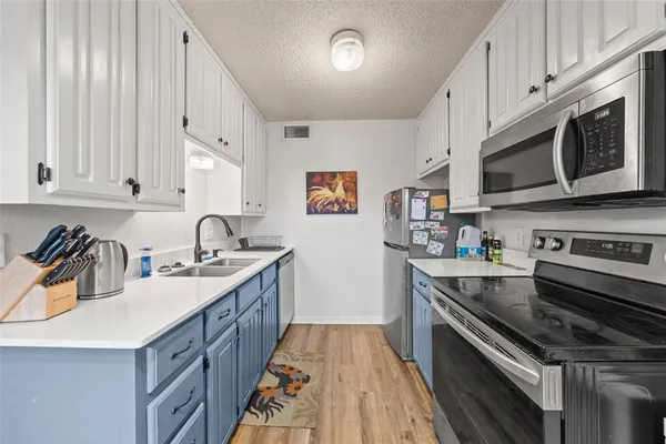a kitchen with stainless steel appliances granite countertop a sink stove and cabinets