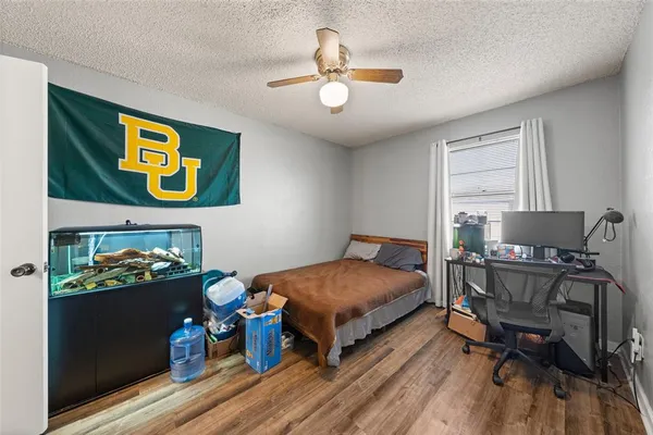 a bedroom with a bed and a chandelier