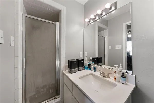 a bathroom with a sink double vanity and a mirror