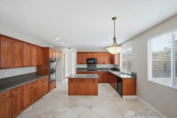 a kitchen with stainless steel appliances granite countertop a sink counter space cabinets and a window