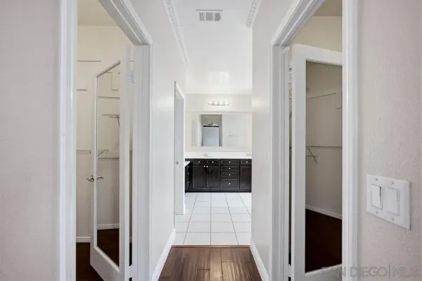 a view of walk in closet with empty racks
