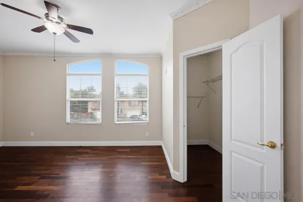 a view of a livingroom with wooden floor and a window