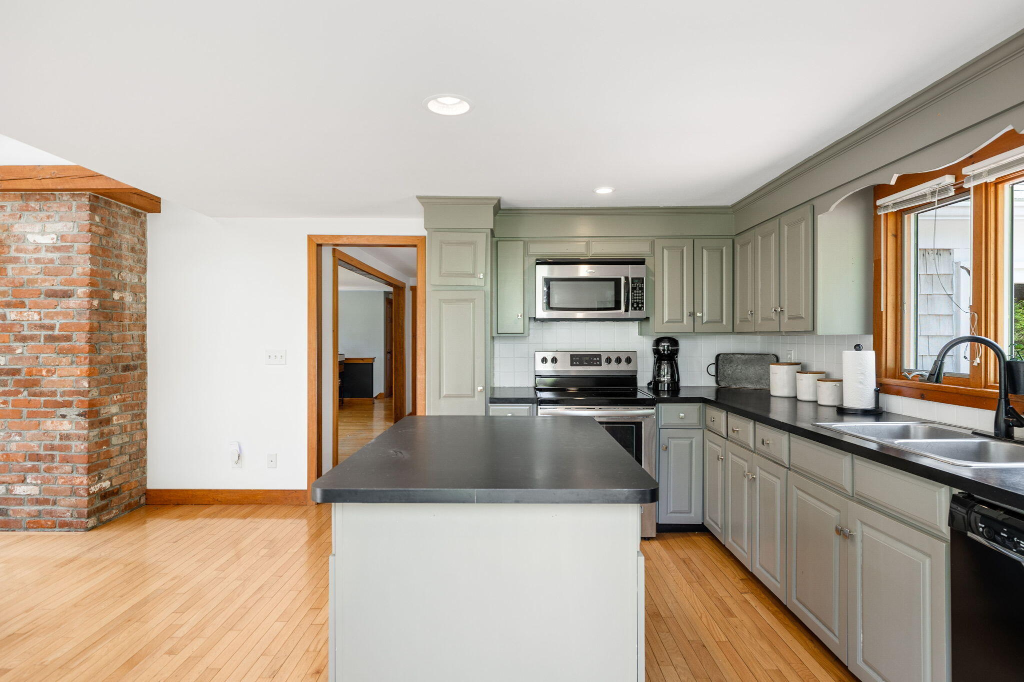 6 Paddock Drive Harwich, MA 02645 - Photo 13 of 40 a kitchen with stainless steel appliances granite countertop a sink a stove top oven a counter space and cabinets